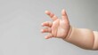 © Susanti - Cute baby hand reaching out against a neutral background, symbolizing innocence and growth