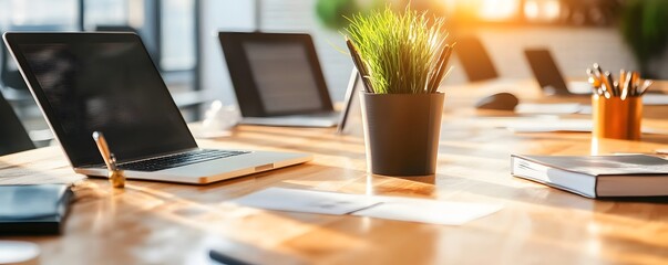 Poster - Modern Office Workspace with Laptop, Plant, and Book.