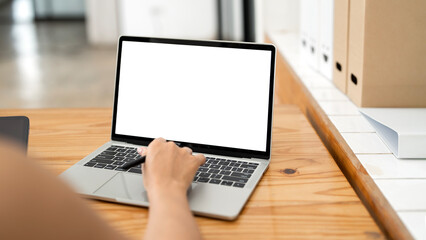 Wall Mural - woman using and typing on laptop with blank white screen. mockup image blank white desktop screen