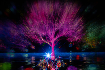 Wall Mural - A mesmerizing light projection of trees in vivid colors illuminates a dark scene, with reflections on the water and a bright starburst at the base. The display radiates vibrant energy and surreal