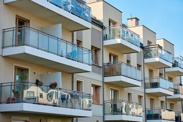 Wall Mural - Multi story apartment building exterior. Residential building facade with balconies at summer day. Modern residential architecture in European city