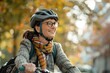 © Igor - A woman wearing a helmet and glasses is riding a bike. She is smiling and she is enjoying her ride