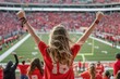 © Igor - back view female fan cheering at a college football game