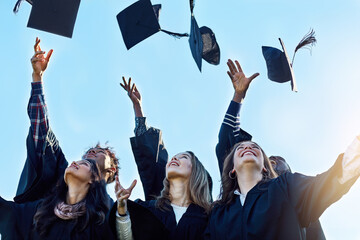 Wall Mural - Students, group and throw graduation cap for success, celebration and happy with goals at college. People, friends and excited with mortarboard in air at event, education and cheers at university