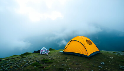 Wall Mural - The misty mountain landscape can be seen from the camping tent set up on a hill overlooking it.