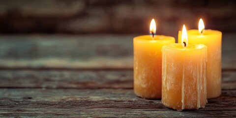 Candles ablaze against a wooden backdrop.