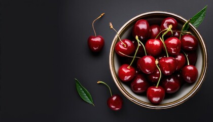 Canvas Print - cherry in a bowl on a black background