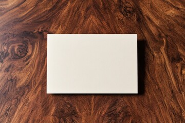 A minimalist blank card placed on a polished wooden surface, ideal for invitations, greetings, or announcements.