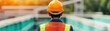 © Chanoknan - Engineer wearing a hard hat while inspecting a water treatment facility under the bright sunlight, ensuring environmental safety