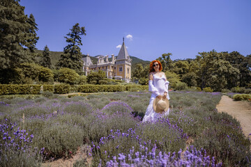 Canvas Print - A woman is standing in a field of purple flowers