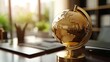 © KYR - Golden globe sitting on a financial desk, symbolizing global finance, international trade, and the power of economic markets