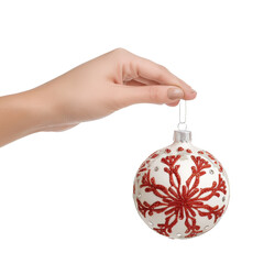 Hand holding a festive red and white christmas ornament with a snowflake design on a transparent background