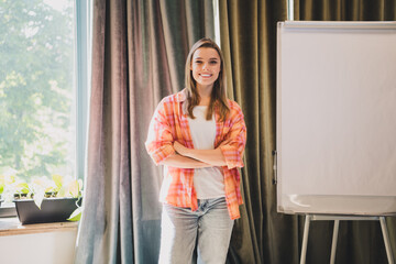 Portrait of pretty young office worker woman crossed arms whiteboard business center indoors