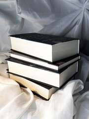 A simple composition of many books, stack or pile of books on white textile background