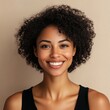 © Руслан Галиуллин - closeup portrait of black softly smiling woman is 35 years old with curly hair on beige background