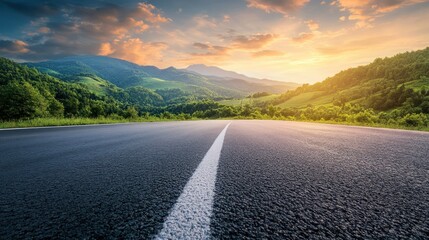 Asphalt Road through Mountain Landscape at Sunset