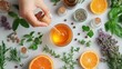 © ibooM - Top view of various herbs, essential oils, and orange slices arranged on a white surface, showcasing natural aromatherapy ingredients.