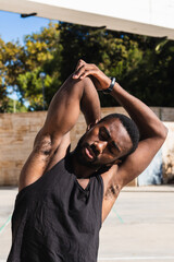 Wall Mural - black man stretching his arms to play basketball