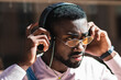 © BUDDHA - Handsome young man listening to music with headphones