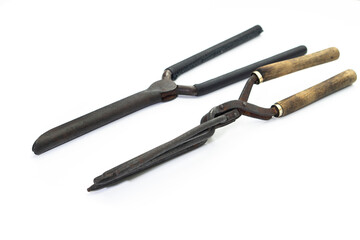 Ancient barber pair of tongs on white background. Vintage curling iron. beauty concept