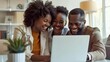 © venusvi - Couple viewing real estate listings on a laptop with agent in modern office
