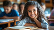 © Michael - Happy young student is grinning while enjoying a book at her desk in the classroom