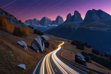 Car light trails on mountain road and high rocks at night in autumn in Passo Giau, Dolomites, Italy.