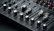 © Enrique - A close up of a black audio mixer with knobs and buttons.