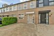 © ADDICTIVE STOCK - Suburban terraced houses with brick facade and parking space