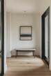 © Lucianastudio - Minimalist entryway with clean lines, a simple bench, and a single piece of artwork on the wall