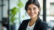 © venusvi - Happy professional woman in formal attire, modern office setting, natural light