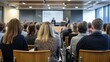 © venusvi - Rear perspective of attendees in a seminar setting, concentrating on a speaker at the podium in a contemporary conference room
