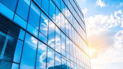 Poster - Sleek modern office building with large glass windows reflecting the sky and surrounding cityscape.