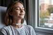 © Milos - A young woman meditates peacefully next to a window in a hospital, capturing a serene moment of mindfulness and tranquility, exuding hope and calm in recovery.