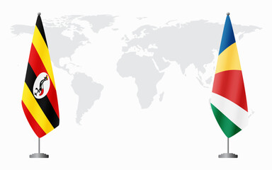 Uganda and Seychelles flags for official meeting against background of world map.