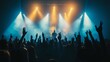 © musa - Silhouetted crowd at a concert with raised hands, illuminated by stage lights.