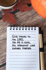 Wall Mural - Christian handwritten quote in notebook for giving thanks to the LORD with coffee cup, pumpkin, and autumn leaves. Top view. Thanksgiving, gratitude, praise to God Jesus Christ, biblical concept.