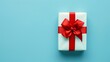 © Francesco - Gift box with red ribbon and bow on a light blue background, minimalistic and festive concept