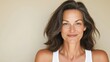 © Trushchenko_O - A woman with brown hair and a white tank top is smiling. She has a lot of hair and it is styled in a way that makes her look very pretty