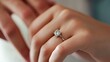 © Matthew - A close-up of a hand wearing an elegant engagement ring, symbolizing love and commitment.