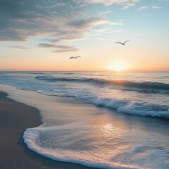 Wall Mural - Seagulls fly over an ocean beach at sunset with soft light and waves lapping on the shore.