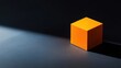 © MakoPoko - Bright orange cube placed centrally on a contrasting dark background, casting strong shadows and highlights.