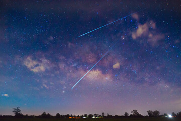 Wall Mural - meteorites fly in the night sky. bright meteors glow in the atmosphere. beautiful shooting stars.