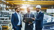 © fotofabrika - Business professionals discussing solar energy solutions in a manufacturing facility during the afternoon