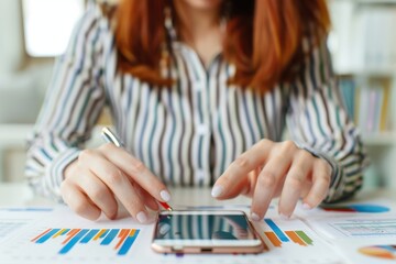 Businesswoman Analyzing Financial Charts and Data with Pen in Hand, focusing on analysis and report preparation.