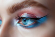 © Martinesku - Closeup view of woman eyes with amazing bright eye makeup in luxurious blue shades. Pink and blue color, colored eyeshadow