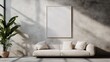 © Maximages  - A minimalist living room featuring a beige couch with three pillows, a large blank framed artwork on the wall, and a potted plant placed beside the couch in soft lighting.