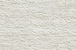 © Aleksander - Textured white fabric cotton chenille surface, showcasing a soft and woven appearance. The fabric has a subtle pattern, ideal for backgrounds or textile design.