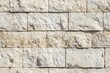 © Aleksander - Textured limestone cladding stone wall made of rectangular blocks in light beige and cream colors, showcasing natural variations and imperfections.