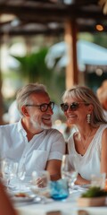 Wall Mural - A couple is sitting at a table with wine glasses and smiling. Scene is happy and romantic